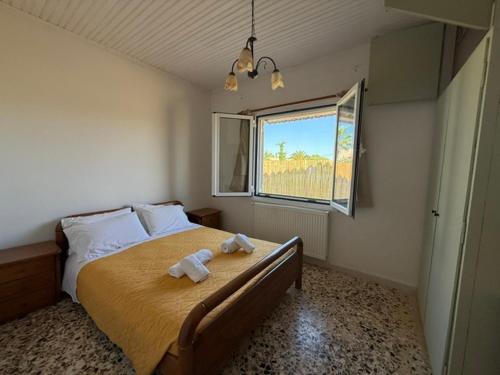 a bedroom with a bed with two towels on it at Antilia corfu 4 in Agios Georgios