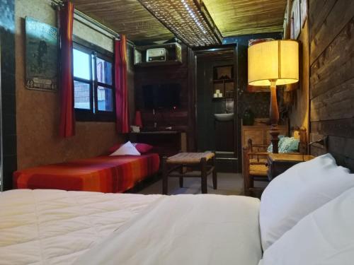 a bedroom with two beds and a desk and a window at Antic house in Agadir