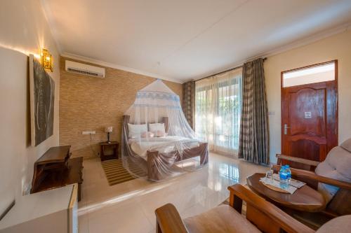 a bedroom with a bed with a canopy at Tan-Swiss Inn in Mikumi