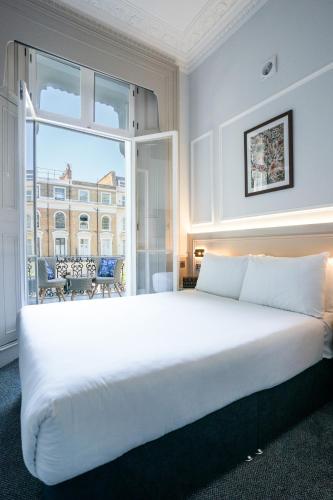 a large white bed in a room with a window at MSK The Whiteley in London