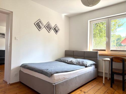 a bedroom with a bed in a room with a window at GM Jagiellończyk in Olsztyn