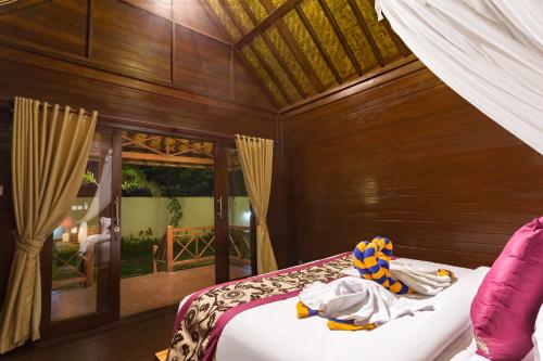 a bedroom with a bed in a room at The Bridge Huts in Nusa Lembongan