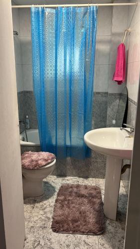 a bathroom with a shower and a toilet and a sink at Villa Pinzon in Moià