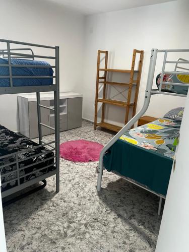 a bedroom with two bunk beds and a rug at Villa Pinzon in Moià