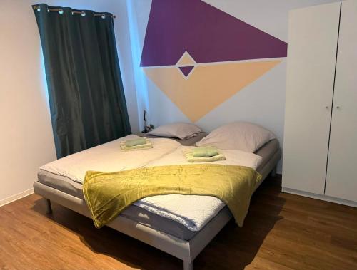 a bedroom with a bed with a purple and yellow canopy at Hostel Nordkirchen by Frerichmann in Nordkirchen