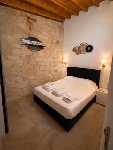 a bedroom with a bed in a stone wall at Arsos Nest in Arsos