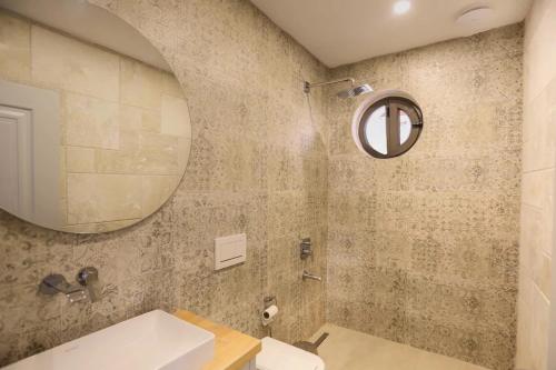 a bathroom with a sink and a mirror at Villa Sydney in Kaş