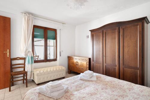 a bedroom with a large bed and a wooden cabinet at Casa Beccari in Cala Liberotto