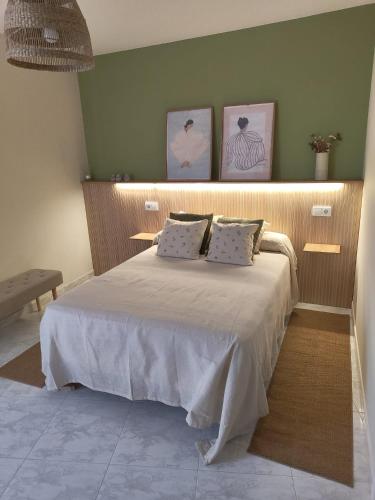 a bedroom with a bed with two pillows on it at Casa do Areal in Laxe