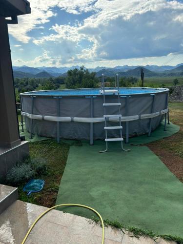 a swimming pool with a ladder next to it at Casa di Kiara, Skadar Lake in Dodoši