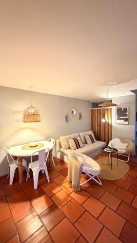 a living room with a couch and a table at Viento Azul Guest House in Punta del Este