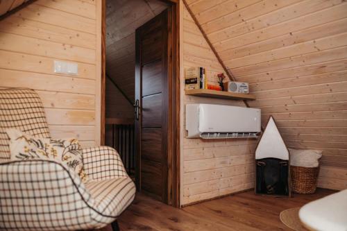 a room with two chairs and a heater in a cabin at Domki & Jacuzzi w Centrum Soliny 885-053-839 in Solina