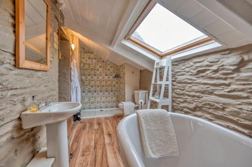 a bathroom with a sink and a bath tub at Finest Retreats - Jabajak Vineyard in Whitland