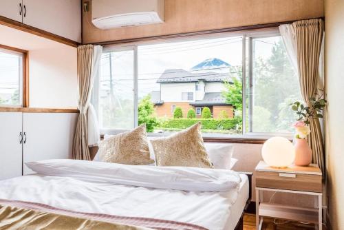 a bedroom with a bed and a large window at Gran kodachi in Fujikawaguchiko