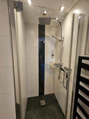a shower with a glass door in a bathroom at Haus Rattenböck in St. Wolfgang