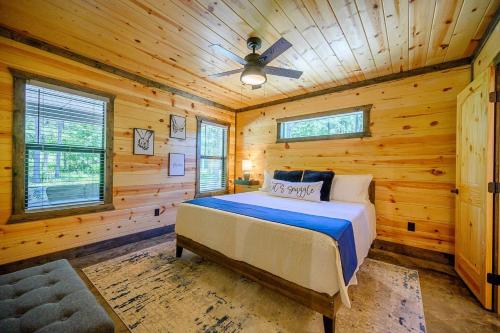 a bedroom with a bed in a log cabin at Private Escape| Hot tub| Fire Pit| Trail Access in Broken Bow