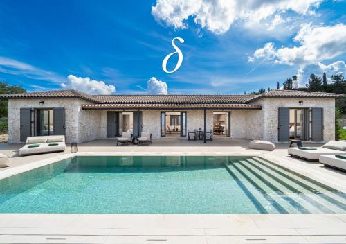 a villa with a swimming pool in front of a house at Horizon Retreat in Fiskardo