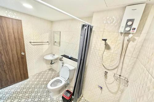 a bathroom with a toilet and a sink and a shower at Baan at Khaosan Hotel in Bangkok