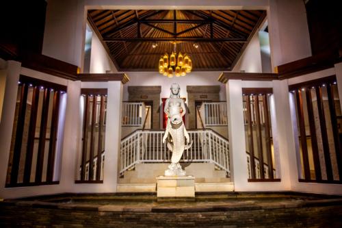 a statue of an elephant standing in front of a building at Puri Santrian Beach Resort And Spa in Sanur