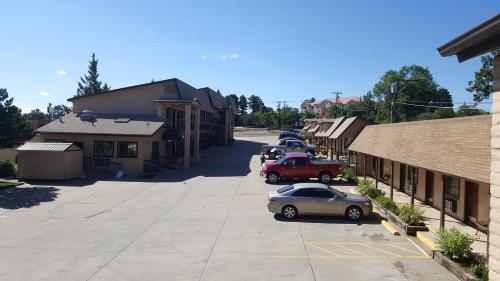 a street in a small town with parked cars at The KC Motel Show Low in Show Low