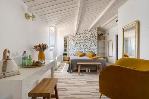 a living room with a bed and a table at Les Chambres De Miloly in La Jarrie