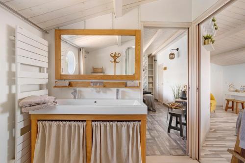 a bathroom with a sink and a mirror at Les Chambres De Miloly in La Jarrie