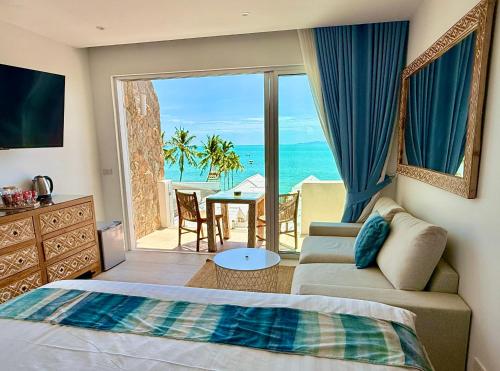 a bedroom with a bed and a view of the ocean at So KohKoon Beach Resort in Bangrak Beach