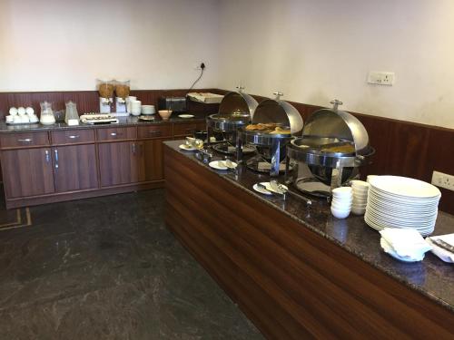 a buffet line in a hotel room with food at The Majestic Crown in Ooty