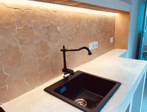 a kitchen sink with a faucet on a counter at Casa Purissima in Ontinyent