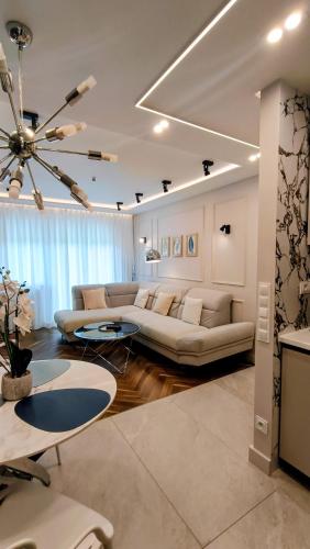 a living room with a couch and a table at THE ONE Apartment in Tomaszów Mazowiecki