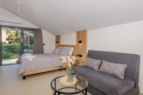 a living room with a bed and a couch at Andelice Zante in Argassi