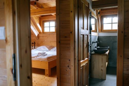 a bedroom with a bed in a wooden house at Výtoň 263 in Přední Výtoň