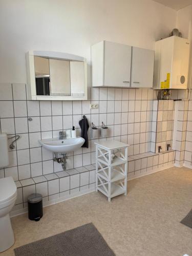 a bathroom with a sink and a toilet at Tolle Moderne Altbau Wohnung in Hohenlockstedt