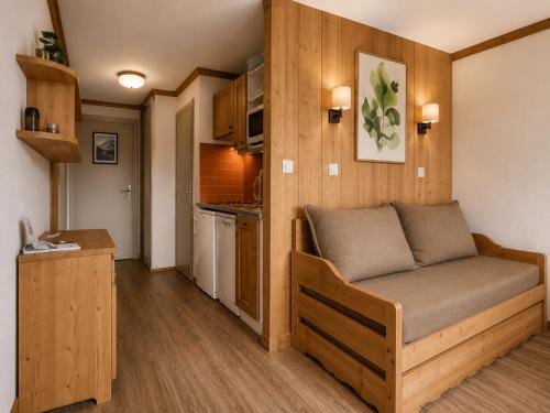 a living room with a couch in a tiny house at Val d'Isère Centre - Emplacement Idéal in Val-d'Isère