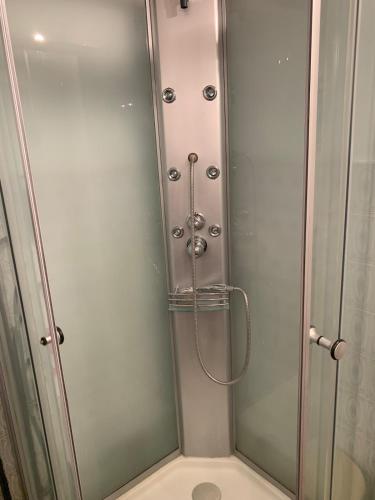 a shower with a glass door in a bathroom at Studio Cosy pied des pistes in Saint-Léger-les-Mélèzes
