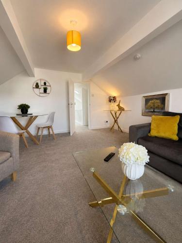 a living room with a couch and a table at New Top Floor Large 1- Bed Flat in Morecambe