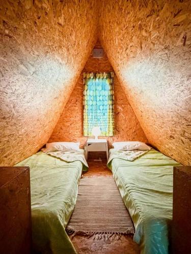a room with two beds and a window at Valley Cabril Selvagem in Cabril