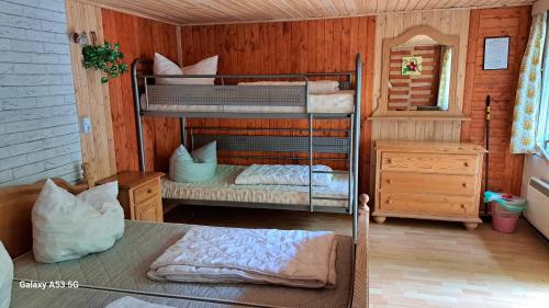a bedroom with two bunk beds in a house at Ferienzentrum Briesensee in Neu Zauche