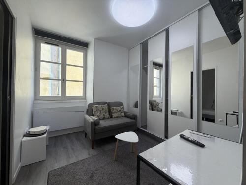a living room with a couch and a chair at La suite Saint Régis 2 in Le Puy-en-Velay