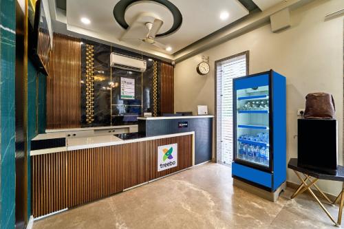 a restaurant with a refrigerator and a counter at Treebo Park View Villa in Jodhpur
