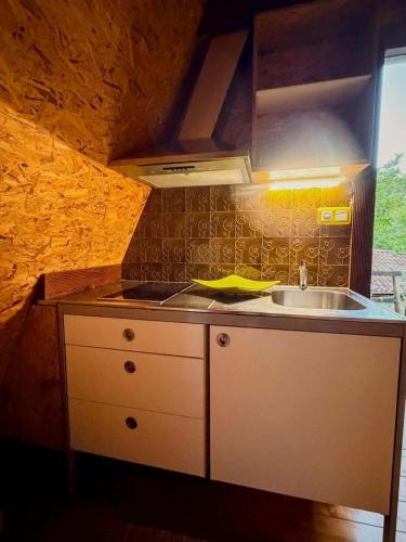 a small kitchen with a sink and a stove at Valley Cabril Selvagem in Cabril