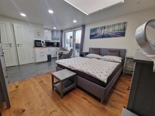 a large bedroom with a bed and a kitchen at Apartment am Rathaus in Heimbach