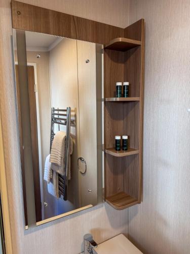a bathroom with a mirror and a toilet in it at UCamp Kemmelberg in Heuvelland