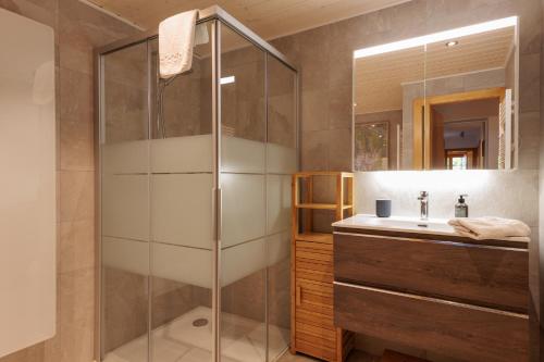 a bathroom with a shower and a sink at Chalet Belle Poncke by Jolidi in Nendaz