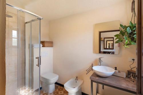 a bathroom with a toilet and a sink and a shower at La Matrice in Garlenda