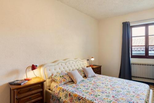 a bedroom with a bed and a window at La Matrice in Garlenda