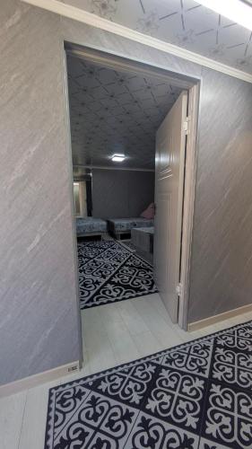 an empty room with a room with beds in it at Koch Iz guest house in Kochkorka