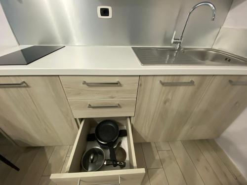 a kitchen with a sink and a drawer with dishes at La casa dell’Aurora in Falcone