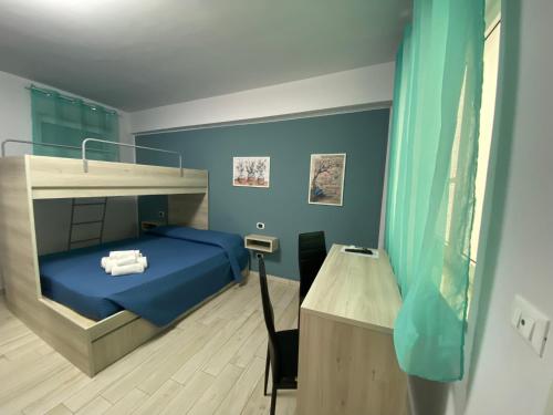 a bedroom with a bunk bed with blue walls at La casa dell’Aurora in Falcone