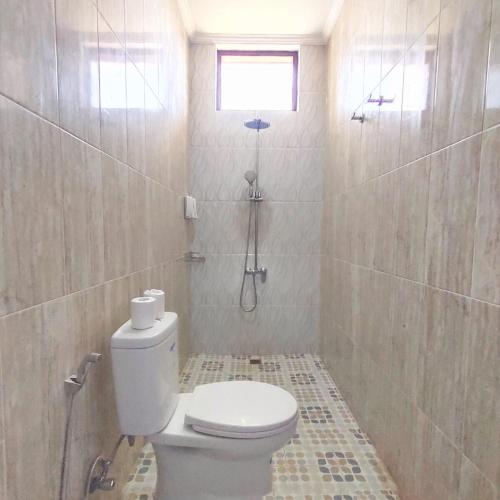 a bathroom with a toilet and a shower at Canggu Rice Field Villa 8B in Dalung